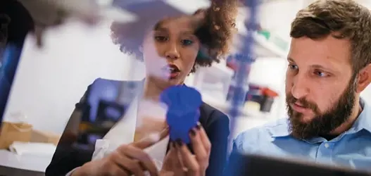 Woman and man looking at product in mid conversation